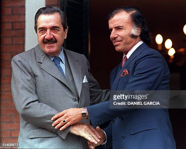 File picture dated 31 May 1989 shows Argentinian President Raul Alfonsin being greeted by President-elected Carlos Menem at the Presidential...