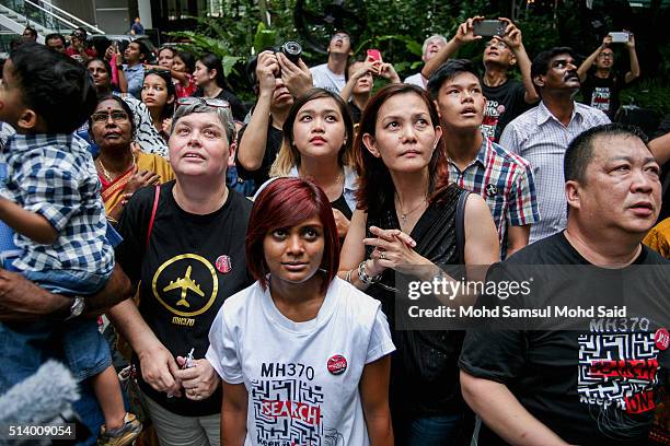 Family members of passengers onboard the missing Malaysia Airlines flight MH370 watch as balloons are released at a remembrance event for Malaysian...