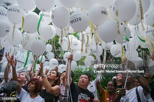 Family members of passengers onboard the missing Malaysia Airlines flight MH370 as balloons are released at a remembrance event for Malaysian...