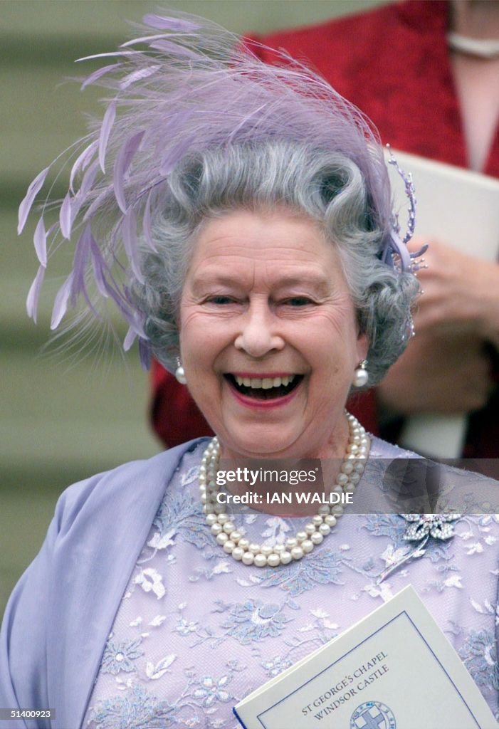 Queen Elizabeth II of England laughs as she leaves