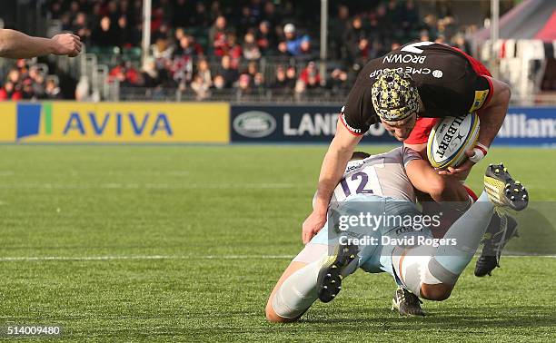 Kelly Brown of Northampton is tackled by Luther Burrell during the Aviva Premiership match between Saracens and Northampton Saints on March 5, 2016...