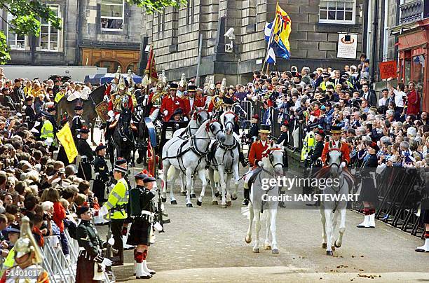 Britain's Queen Elizabeth 11, in a horse-drawn carriage, arrives to open the new Scottish Parliament in Edinburgh 01 July 1999. The Queen opened the...