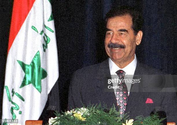 Smiling Iraqi President Saddam Hussein gives a speech 17 July 1999 in Baghdad, during celebrations marking the 31st anniversary of the Baath party...