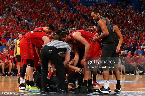 The referee attempts to retrieve the ball after Reuben Te Rangi of the Breakers and Shawn Redhage of the Wildcats dived on a loose ball during game...