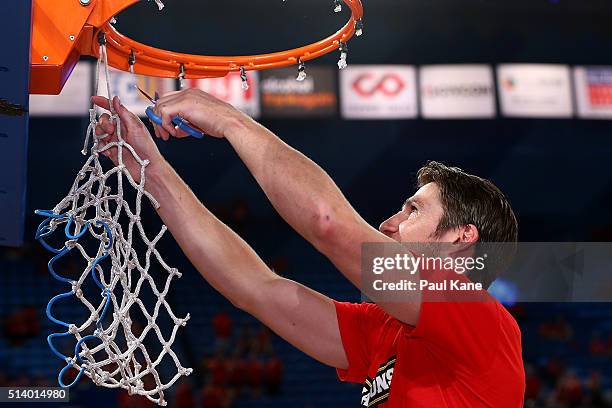 Damian Martin of the Wildcats snips the net after winning the Championship during game three of the NBL Grand Final series between the Perth Wildcats...