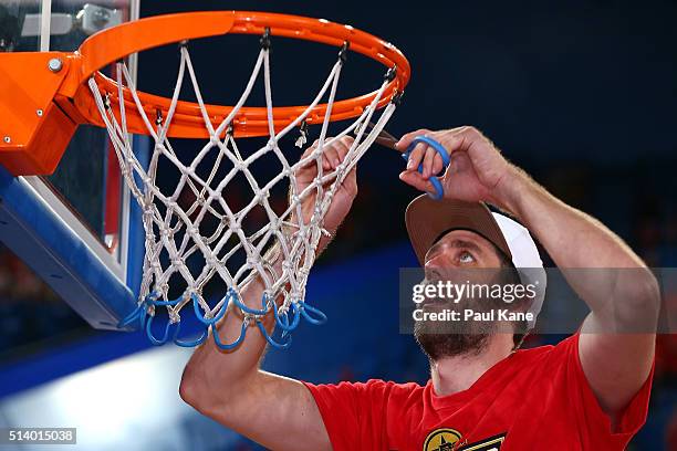 Tom Jervis of the Wildcats snips the net after winning the Championship during game three of the NBL Grand Final series between the Perth Wildcats...