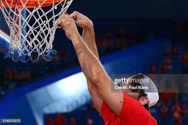 Matt Knight of the Wildcats snips the net after winning the Championship during game three of the NBL Grand Final series between the Perth Wildcats...