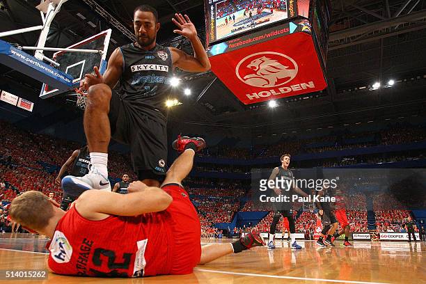 Mika Vukona of the Breakers steps over Shawn Redhage of the Wildcats after a contest for a loose ball during game three of the NBL Grand Final series...
