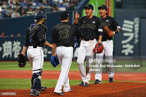 Pitcher Ginjiro Sumitani#27, Yuji Nishino, Infielder Hayato Sakamoto and Infielder Nobuhiro Matsuda of Japan celebrate their win in the international...