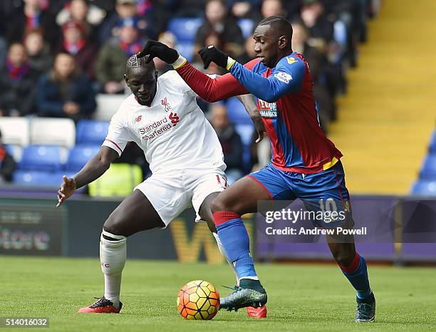 Mamadou Sakho of Liverpool competes with Yannick Bolasie of Crystal Palace during the Barclays Premier League match between Crystal Palace and...