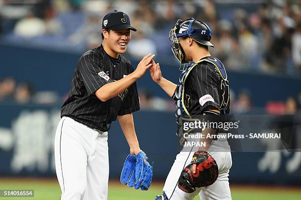 Pitcher Yuji Nishino and catcher Ginjiro Sumitani of Japan celebrate their win in the international friendly match between Japan and Chinese Taipei...