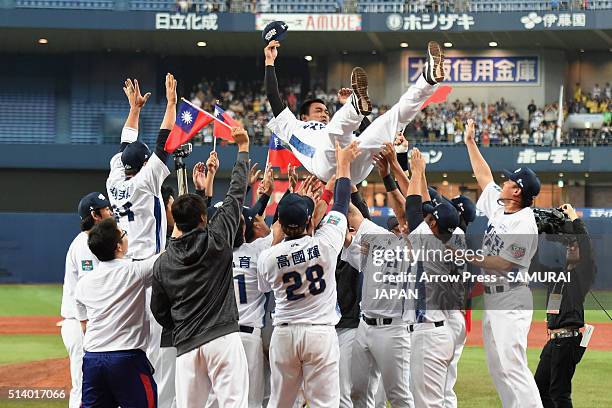 Outfielder Chen Chin-Feng of Chinese Taipei is thrown into the air during his retirement ceremony from the national team after the international...