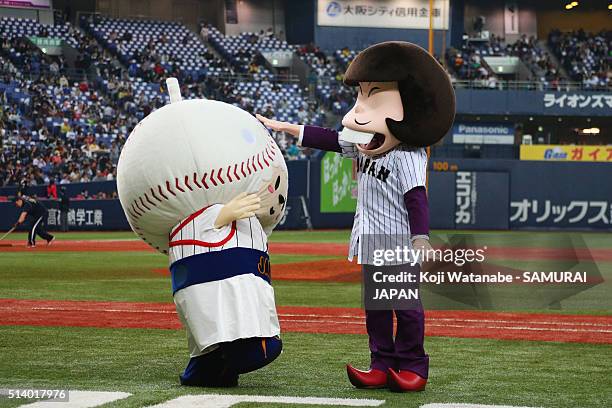 Famous cartoon character Iyami and Samurai Japan supporting character Tamabe entice fans during the international friendly match between Japan and...