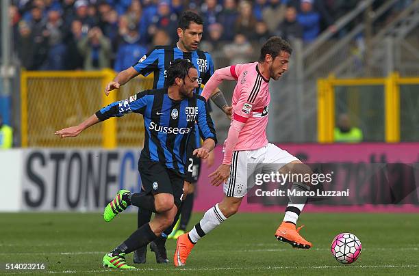 Claudio Marchisio of Juventus FC competes for the ball with Luca Cigarini and Marco Borriello of Atalanta BC during the Serie A match between...