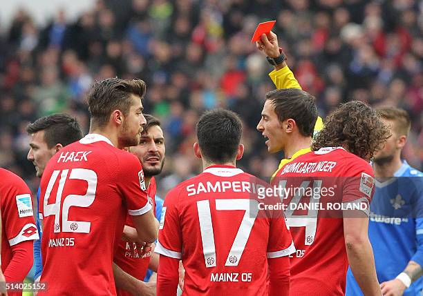 Referee Benjamin Brand shows a red card to Mainz' Italian defender Giulio Donati during the German first division Bundesliga football match of FSV...