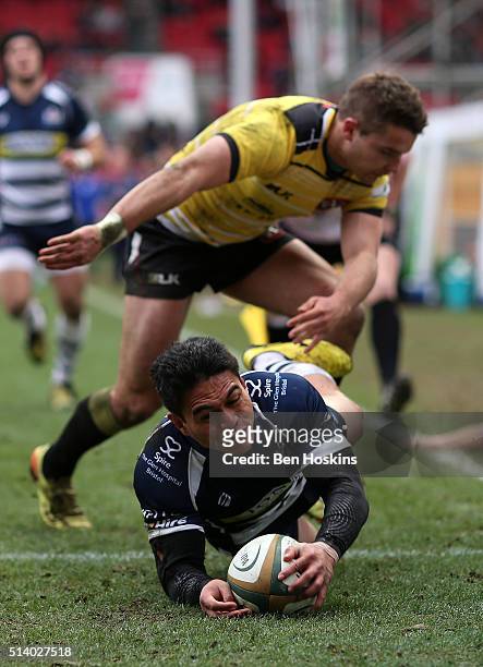 David Lemi of Bristol scores a try under pressure from Laurence May of Cornish Pirates during the Greene King IPA Championship match between Bristol...