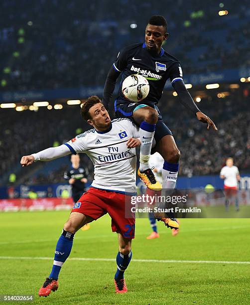 Salomon Kalou of Berlin is challenged by Nicolai Müller of Hamburg during the Bundesliga match between Hamburger SV and Hertha BSC at...
