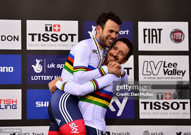 Mark Cavendish and Sir Bradley Wiggins of Great Britain celebrate on the medal podium after winning The Men's Madison Final during Day Five of the...