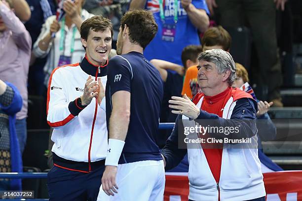 Andy Murray of Great Britain celebrates victory with his brother Jamie Murray following the singles match against Kei Nishikori of Japan on day three...