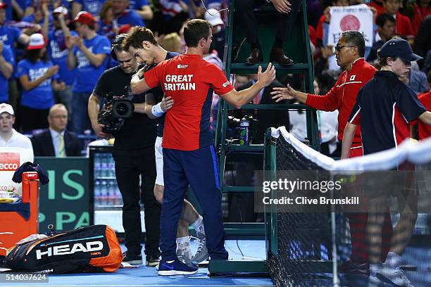 Leon Smith the Great Britain team captain shakes hands with Minoru Ueda the Japan team captain following the singles match between Andy Murray of...