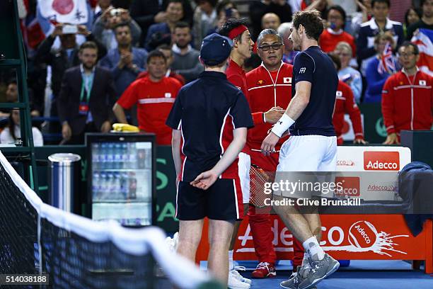 Andy Murray of Great Britain shakes hands with Kei Nishikori of Japan following their singles match on day three of the Davis Cup World Group first...