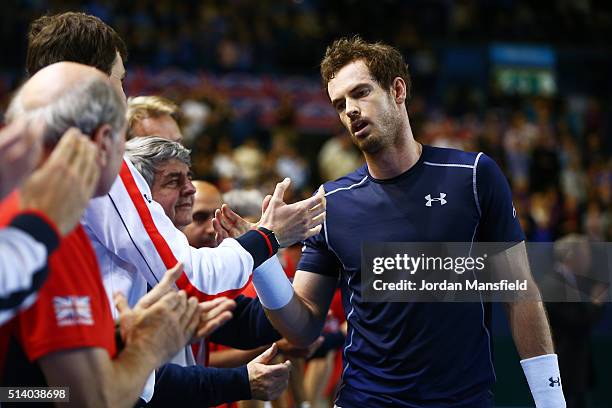 Andy Murray of Great Britain celebrates with teammates following his victory during the singles match against Kei Nishikori of Japan on day three of...