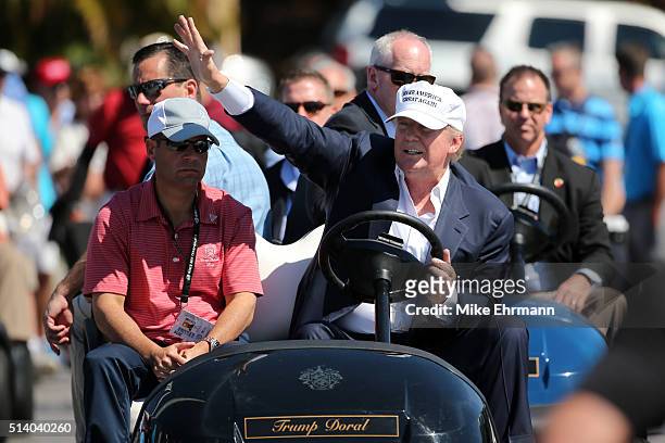 Republican presidential candidate Donald Trump makes an appearance prior to the start of play during the final round of the World Golf...