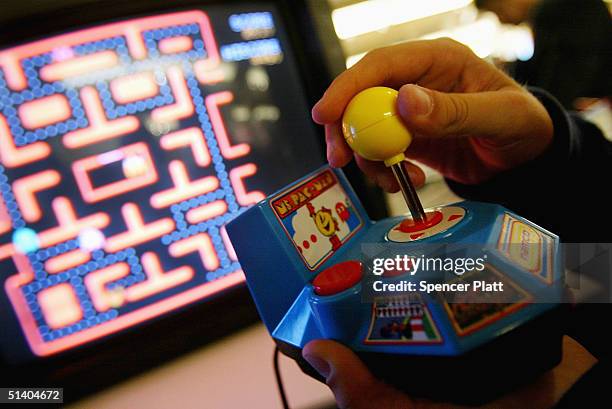 Person plays the new Ms. Pac-Man game by JAKKS Pacific, Inc. At the Toy Industry Association & Toy Wishes Holiday Preview show October 5, 2004 in New...