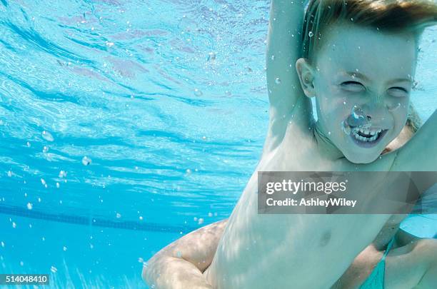 summer laughing underwater - underwater wrestling stock pictures, royalty-free photos & images