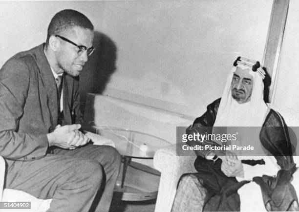 American civil rights leader Malcolm X sits and meets with Prince Faisal al-Saud the regent of Saudi Arabia during a visit as a guest of state and as...