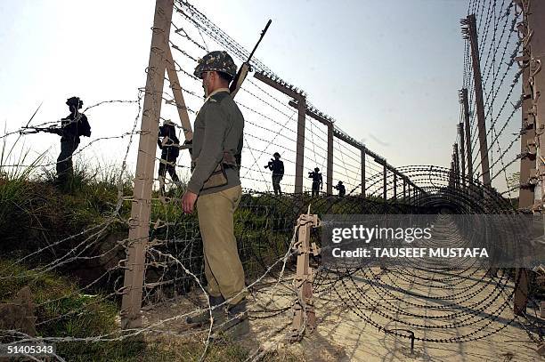 Troopers of the Border Security Force patrol near the Line of Control that divides Indian and Pakistani Kashmir at Ramgarh sector, 27 December 2001....