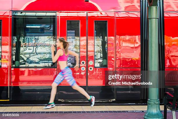 running downtown next to a trolley - center athlete stock pictures, royalty-free photos & images