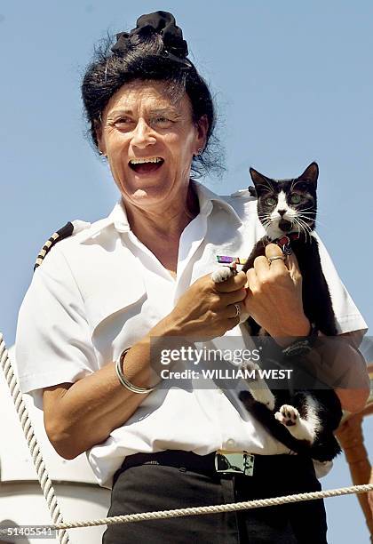 Captain of the Tall ship Windeward Bound Sarah Parry waves farewell with the paw of ship cat 'Trim' as they depart on a re-enactment of Australian...