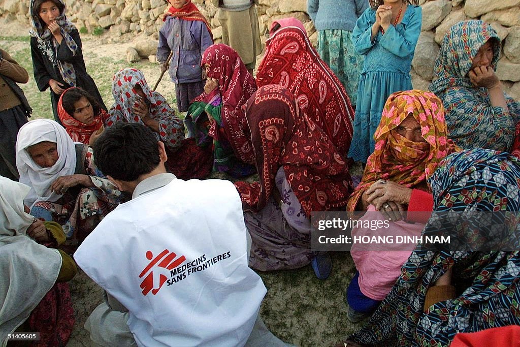 Women sit around an aid worker from Medecins Sans