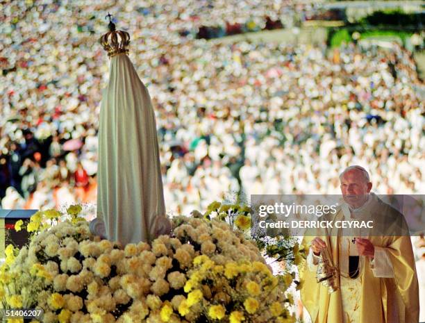 Pope John Paul II celebrates a mass 12 May 1991 in the Chapel of the Apparition in front of the statue of Virgin of Fatima in Fatima where about a...