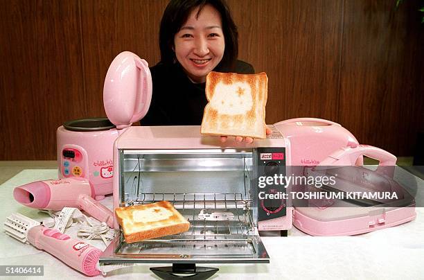 Yukari Miyashita of Sanyo Electric's Tokyo Corporate Communications shows off a slice of bread toasted by Sanyo's new oven toaster of "Hello Kitty"...