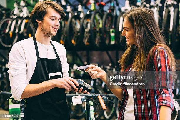 paying with a credit card - buying a bike bildbanksfoton och bilder