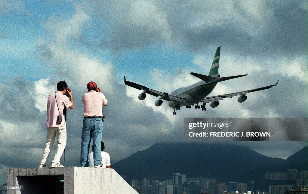 Two people climb onto a rooftop in Kowloon City 13
