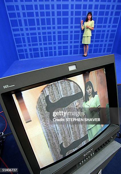 Saleswoman for Orad Hi-Tec Systems stands on a blue virtual studio and knocks on a door, generated in a 3D realtime cyber set, hoping to lure...