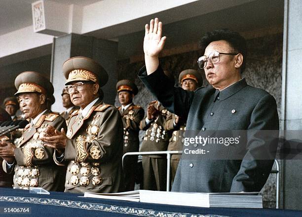 North Korean leader Kim Jong-Il waves at a military parade to celebrate the 50th anniversary of the founding of the Workers' Party of Korea in a file...