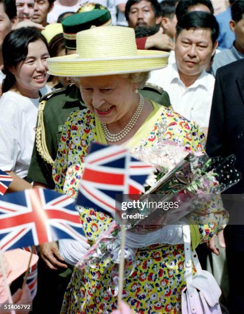 Visiting British monarch Queen Elizabeth II is greeted by British nationals and Bruneians upon her arrival at a market in capital Bandar Seri Begawan...