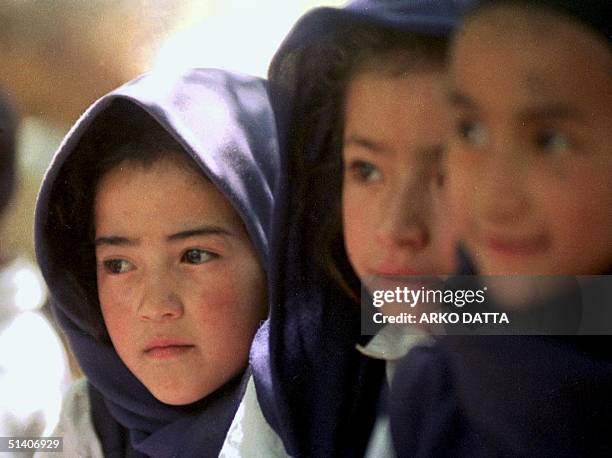 Children of refugees study in a makeshift school 15 July 1999 in Minji in Kargil sector in Indian held Kashmir. The migrants are hopeful that after...