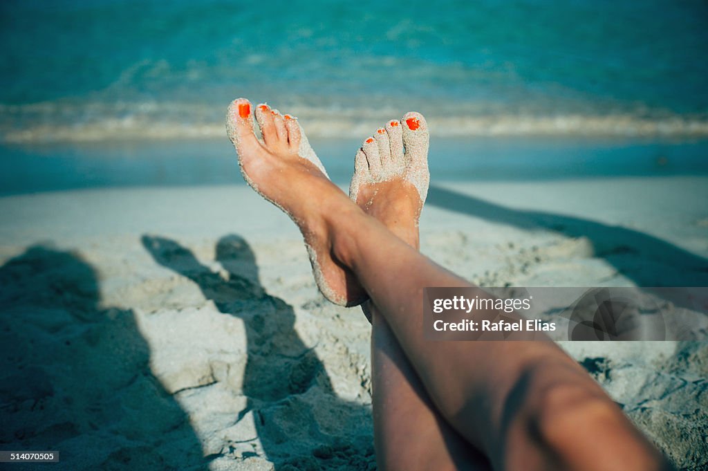 Woman feet on beach