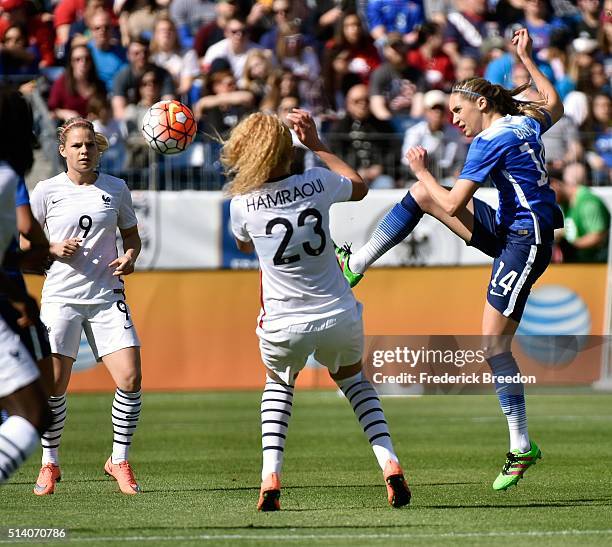 Morgan Brian of USA kicks the ball past Kheira Hamraoui of France during an international friendly match of the SheBelieves Cup at Nissan Stadium on...