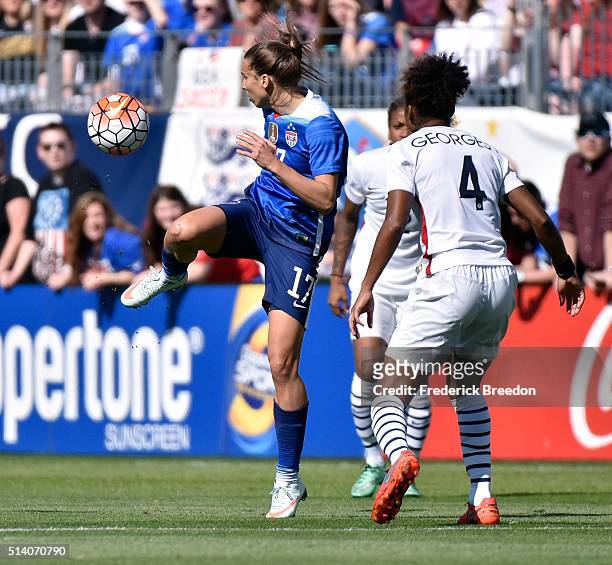 Laura Georges of France watches Tobin Heath of USA kick the ball during an international friendly match of the SheBelieves Cup at Nissan Stadium on...