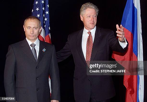 President Bill Clinton and Russian Prime Minister Vladimir Putin decline to answer questions during a photo opportunity in the lobby of the Stamford...