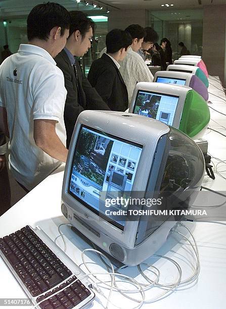 Journalists looks at iMac DV special edition and other updated versions of the iMac computer in Tokyo 07 October 1999. Apple computer Japan announced...