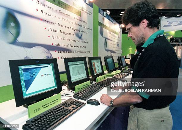 An exhibitor testing software applications at the Sapphire '99 expo managed by germany-based SAP AG at the Singapore International Convention and...