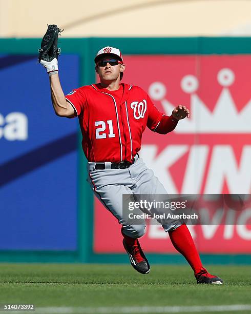 Matt den Dekker of the Washington Nationals fields the ball hit by Carlos Peguero of the St Louis Cardinals in the event inning of a spring training...