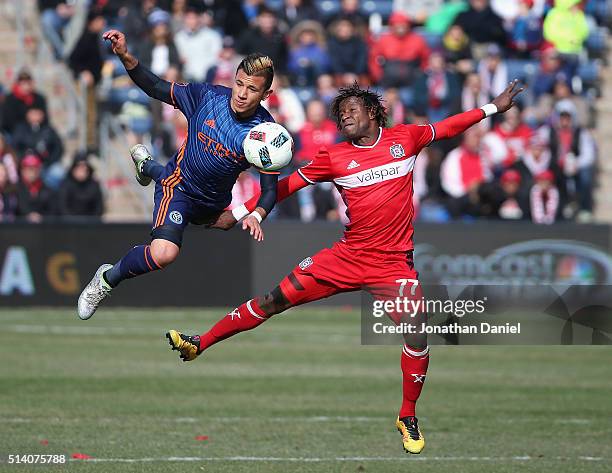 Mikey Lopez of the New York City FC and Kennedy Igboananike of Chicago Fire go airborne as they battle for the ball at Toyota Park on March 6, 2016...